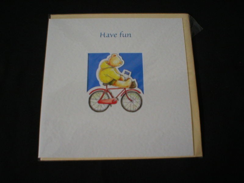 MEDICI CARD HAVE FUN DEPICTING A BEAR ON A BIKE.