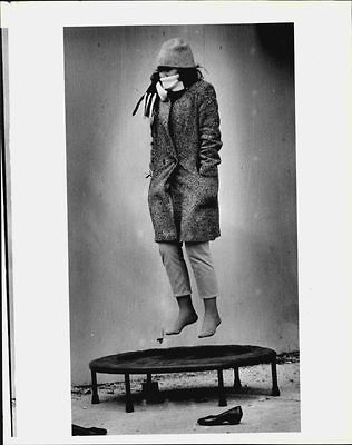 1980 s woman in hat coat on mini trampoline press