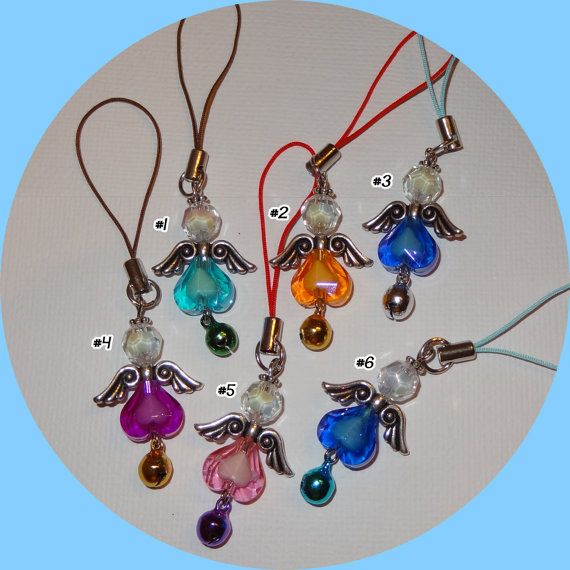   beads, metal wings, and a bell; and attached to a cell phone strap